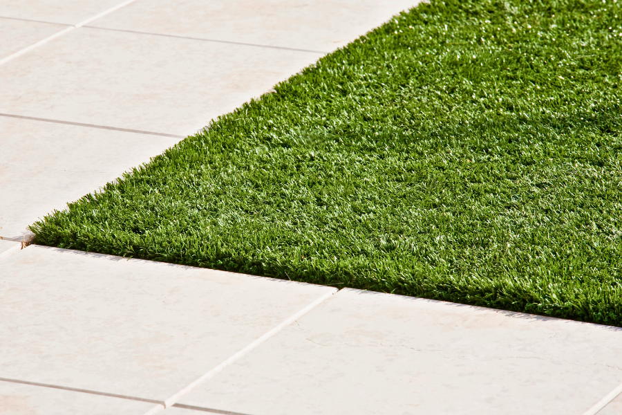 Fresh lawn meets with sidewalk corner, cleanly trimmed